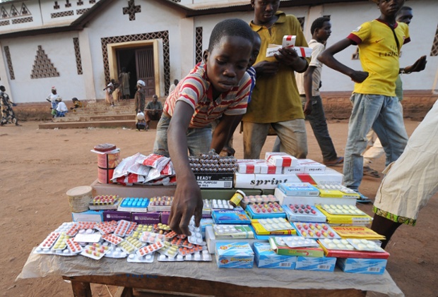 A boy sells goods including medicine and cigarettes in a camp for internally displaced people at the Catholic church in Bossangoa,  Central African Republic.