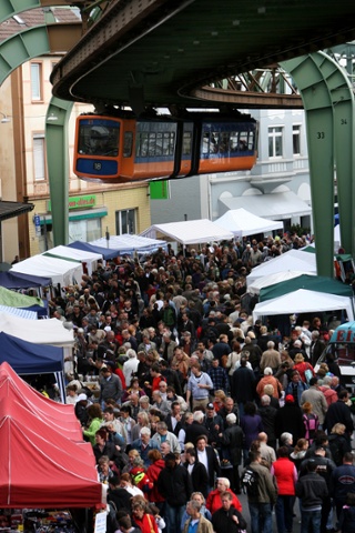 An elevated train passes over a flea market in the Vohwinkel district in the city of Wuppertal, Germany.