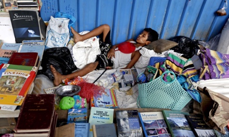 Too many books. Time for a snooze.  EPA/NYEIN CHAN NAING epaselect