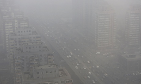Cars drive on the Three Ring Road amid heavy haze in Beijing in February 2014