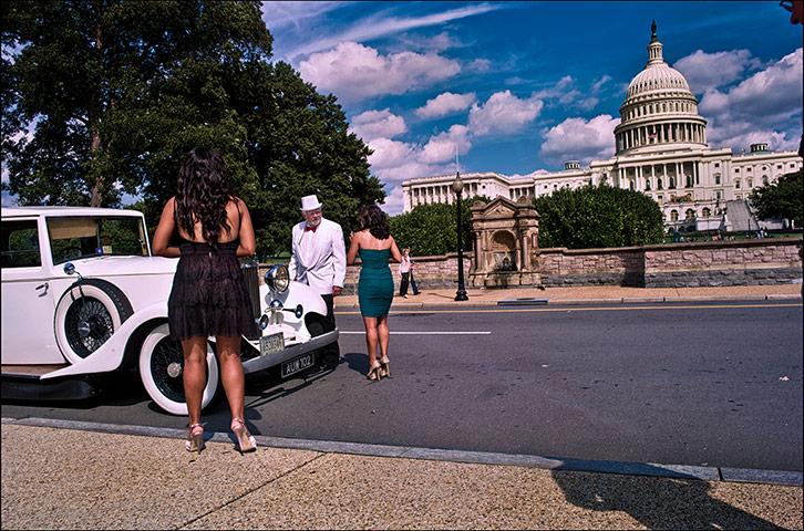 Pennsylvania: A top-hatted driver stands next to his vintage Rolls Royce on a scenic tour