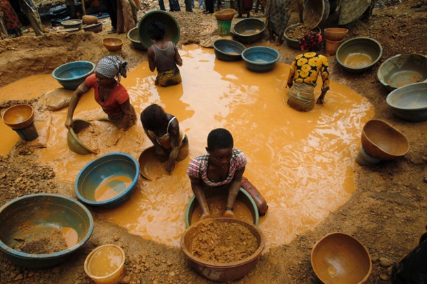 Prospectors pan for gold at a new gold mine found in a cocoa farm near the town of Bouafle, Ivory Coast. 