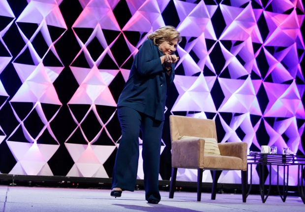 Former Secretary of State Hillary Clinton ducks after a woman threw an object at her while she was delivering remarks at the Institute of Scrap Recycling Industries conference in Las Vegas.