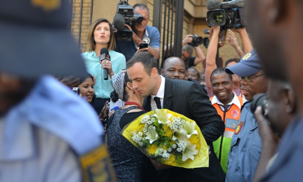A woman hugs South African athlete Oscar Pistorius after handing him flowers as he leaves the North Gauteng Hight Court in Pretoria during his ongoing murder trial. The prosecution have accused Pistorius of tailoring evidence and overplaying his deep fear of crime to justify shooting dead his girlfriend Reeva Steenkamp.
