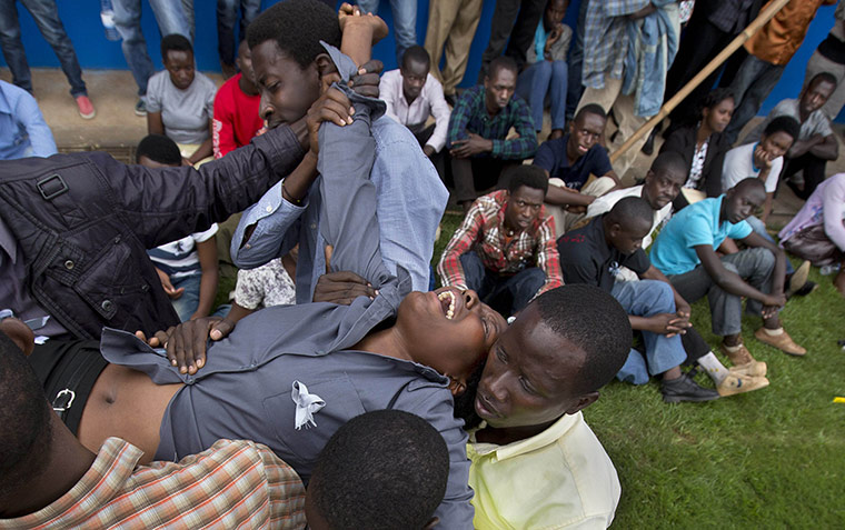 20 Photos: A distraught Rwandan woman is overcome by grief in Kigali