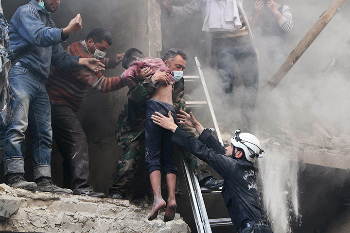 20 Photos: Men rescue a boy from under the rubble of a buildingin Aleppo