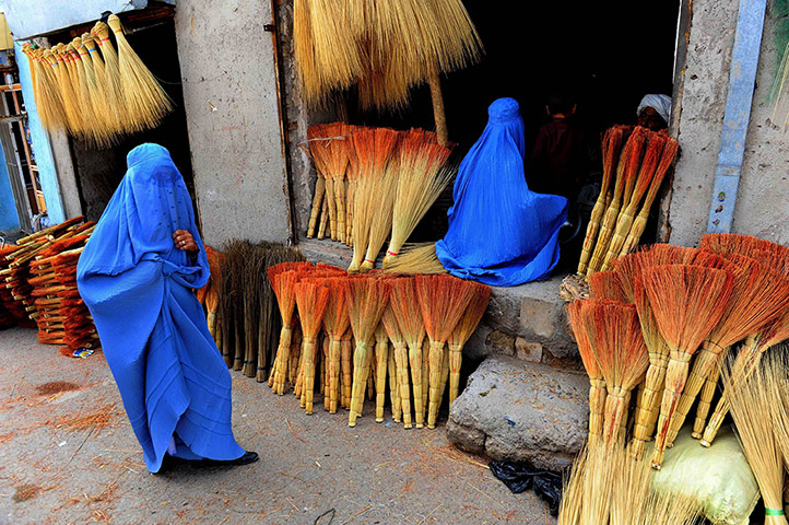 20 Photos: Afghan shoppers look for brooms at a roadside shop in Herat