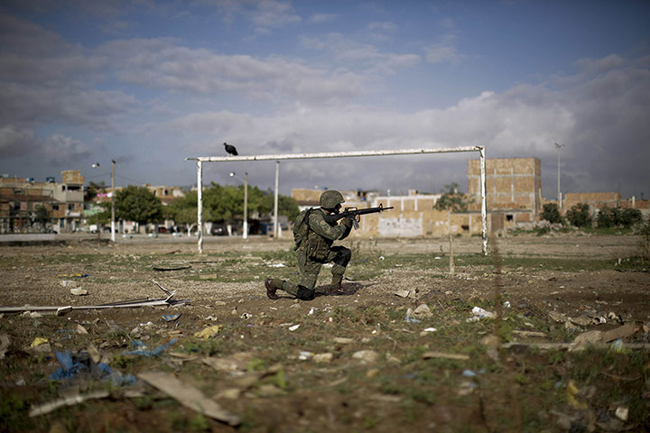 20 Photos: A soldier on a football field during an operation at the Mare slum in Rio