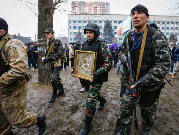 Pro-Russian protesters escort a man carrying an icon, which they said was found in the seized office of the SBU state security service, in Luhansk, eastern Ukraine.