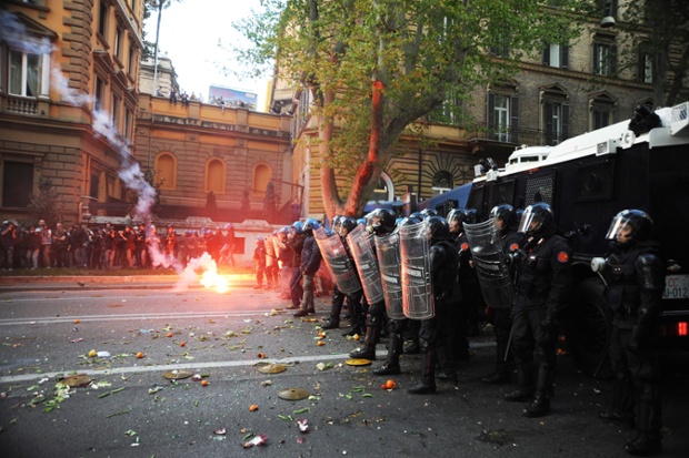 Riot police and protesters clash as thousands of people demonstrate against the Italian government's austerity measures in Rome.