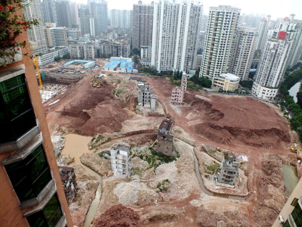 February 2013: Nail houses are isolated by man-made ditches on the construction site in Yangji village, Guangzhou city