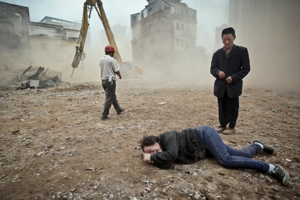 March 2012: A woman who tried to protect her house from being demolished cries at Yangji village in Guangzhou city.