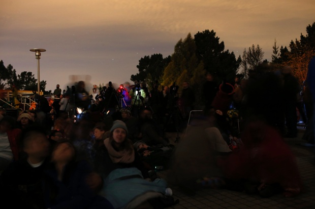 People gather at the Chabot Space and Science Center for a glimpse of the total lunar eclipse in Oakland, California.