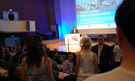 Berlin: April 14th 2014. Sigmar Gabriel speaking at the IPCC WG3 briefing. Future protestors watch him in silence.