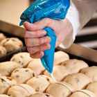 Hot cross buns being iced