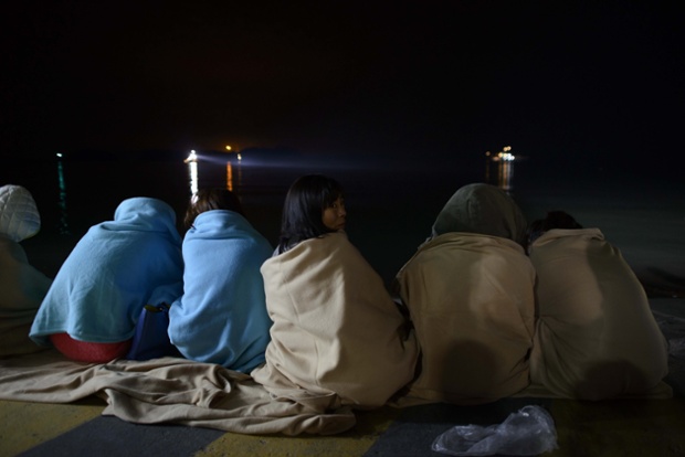 Relatives wait for news about the capsized ferry at a harbour in Jindo. South Korean rescue teams race to find up to 293 people still missing.