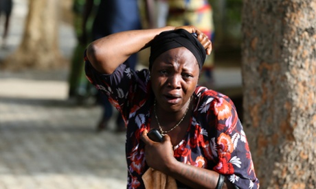 A bystander reacts as victims of a bomb blast arrive at the Asokoro General Hospital in Abuja on 14 April, 2014.