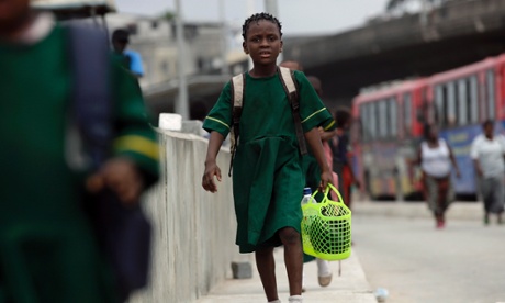 A girl walks to school in Lagos, Nigeria.