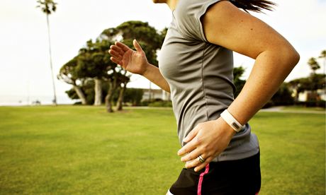 Hispanic woman running in park field