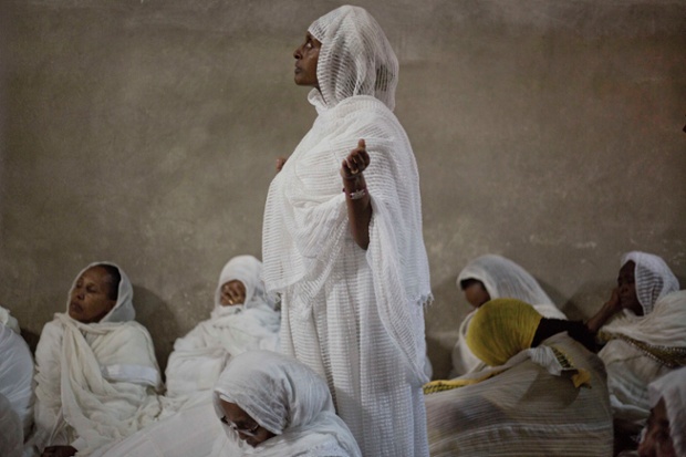 Ethiopian Orthodox Christian women pray at Deir El Sultan during the Washing of the Feet ceremony outside the Church of the Holy Sepulchre, traditionally believed by many to be the site of the crucifixion and burial of Jesus Christ, in Jerusalem.