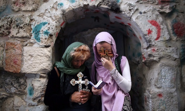 Orthodox Christian worshippers hold crosses during a Good Friday procession on the Via Dolorosa, retracing what many believe to be the route Jesus Christ took before his crucifixion, in the Old City of Jerusalem.