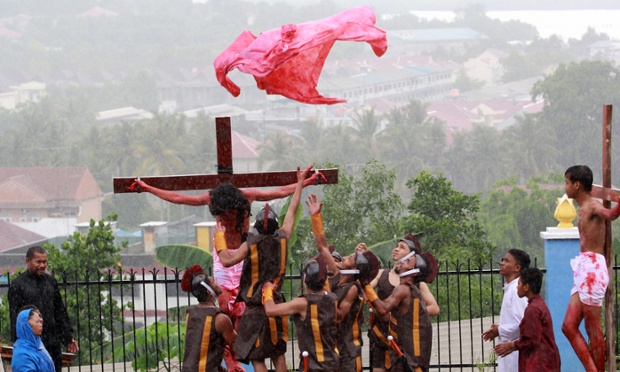 Indonesians perform the tenth station 'Jesus is stripped of his garments' during a re-enactment of the Stations Of The Cross on Good Friday at the Raja Agung church in Bintan Island.