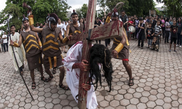 Indonesians take part in a re-enactment of the Stations of the Cross on Good Friday at the Raja Agung church, Indonesia