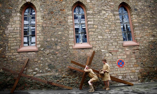 Performers carrying their cross before they take part in a re-enactment in Bensheim, Germany.