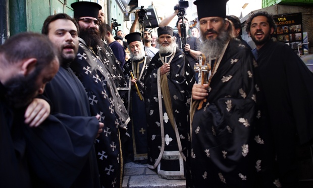 Greek Orthodox priests take part in the Good Friday procession along the Via Dolorosa in Jerusalem.