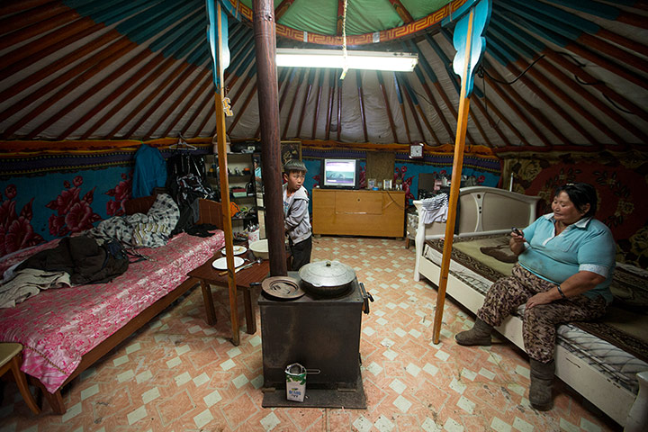 Mongolia gallery: Asthma suffers Jugder Batmunkh inside her Ger with her coal burner. 