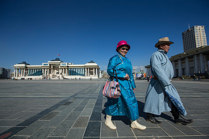 Mongolia gallery:  A couple in traditional dress walk through Sukhbaatar Square.
