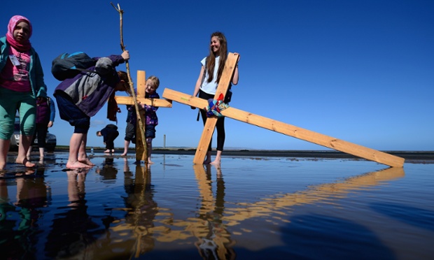 The Northern Cross pilgrimage undertakes its final leg of the journey to Holy Island in Berwick-upon-Tweed, UK crossing the tidal causeway during the annual Christian pilgrimage.