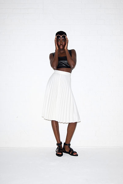 All Ages monochrome: black faux leather bralet white pleated skirt black sheos sunglasses