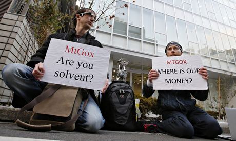 Protesters hold placards as they demonstrate against Mt. Gox in Tokyo
