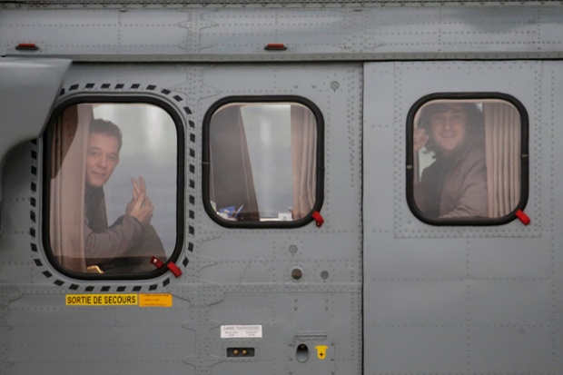 Villacoublay, France: Radio journalist Didier François (left) and photojournalist Edouard Elias (right) look out of the window of a helicopter as they arrive at a military airbase. They and two other journalists were released after being held captive by kidnappers in Syria for more than 10 months