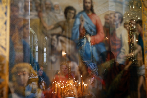 Donetsk, Ukraine: Orthodox worshippers light candles inside a church during Easter Sunday celebrations