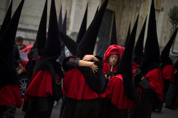 Bilbao, Spain: Penitents embrace before taking part in an Easter Holy Week procession
