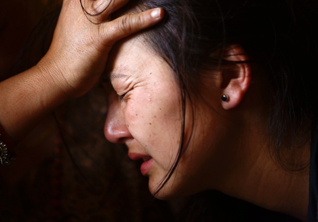 Kathmandu, Nepal: A daughter of one of the 12 mountain guides who were killed in Friday's avalanche on Mount Everest, is comforted by a relative at a monastery