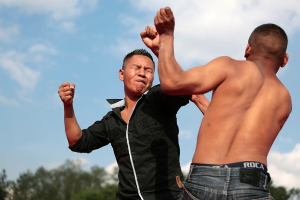 Chivarreto, Guatemala:  Two men participate in a traditional Good Friday bare-knuckle fight.