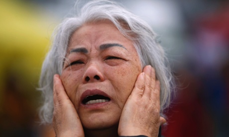 A woman shows her grief at Jindo port where relatives have been waiting while bodies are recovered from the sunken ferry Sewol.