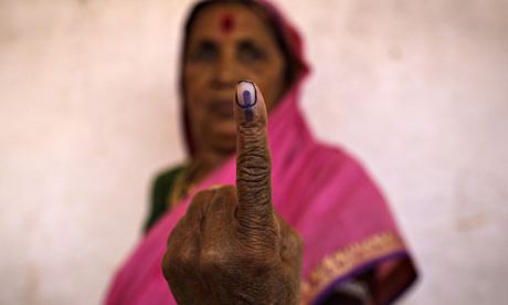A woman shows her ink-marked finger 