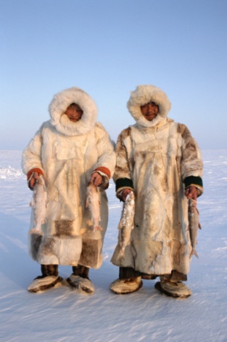 Nenets reindeer herders, Sasha Yeyvi (right) with Sertoharby, his grandfather hold Broad Whitefish they have just caught under the ice. Gydan, W.Siberia, Russia. 2000