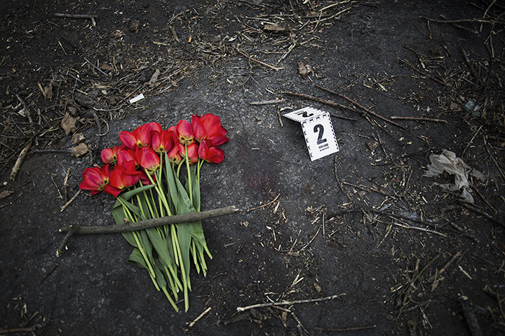 20 Photos: A bouquet next to bloodstains and a police evidence marker in Ukraine