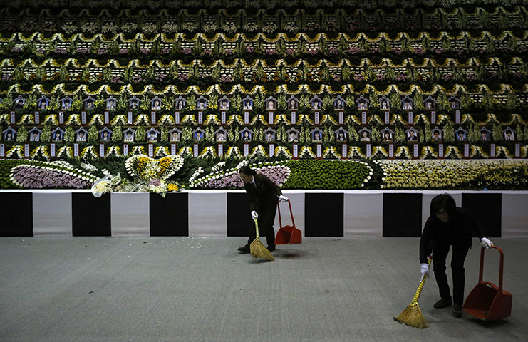 20 Photos: Employees sweep the floor in front of a memorial altar in Ansan