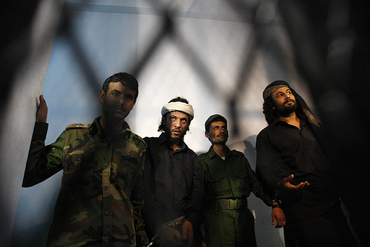20 Photos: Suspected al-Qaida militants stand behind bars in Sanaa, Yemen