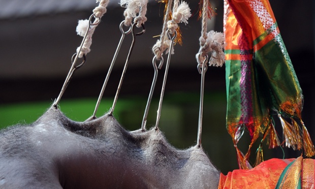 A Sri Lankan Tamil Hindu devotee hangs from hooks inserted into his skin during a ceremony at a Hindu temple in Colombo.