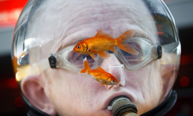 A man wearing a water jar filled with live fish over his head at the opening ceremony of the 20th edition of the international film festival 'Visions du Reel' in Nyon, Switzerland.