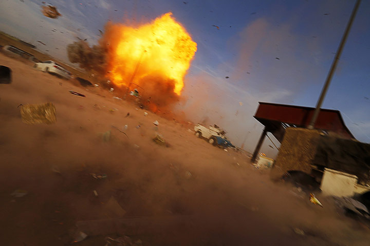 20 Photos: A car bomb detonates at a Shi'ite political rally in Baghdad
