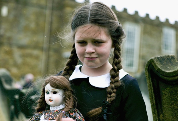 Colette Rimmer, 10, from Wigan poses with a spooky doll. ~ Getty Photograph by Ian Forsyth