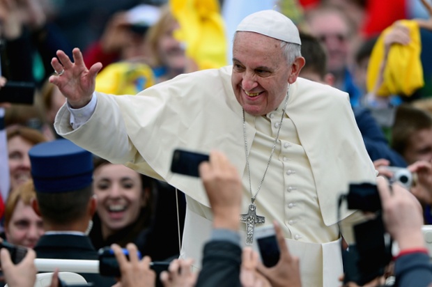 Pope Francis waves to pilgrims gathered in St Peters Square following the canonisation mass.